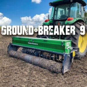 A green tractor with the words ground breaker 9.