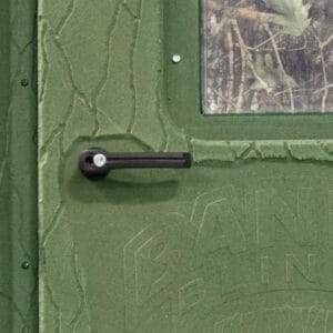 A green door with a camouflage pattern on it.